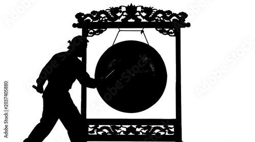 Man hitting a large metal gong.