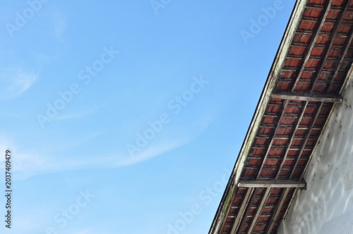 Traditional Roof Corner Against Blue Sky