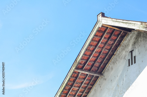 Traditional House Roof Under Blue Sky