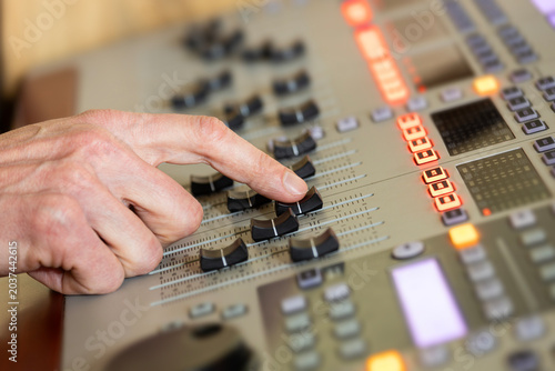 Schilderij op canvas Sound engineer adjusting fader on audio mixer