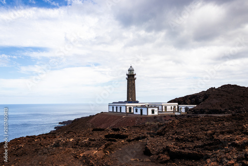 Canvas Print Faro de Orchilla lighthouse standing on a rugged black lava field by the Atlanti