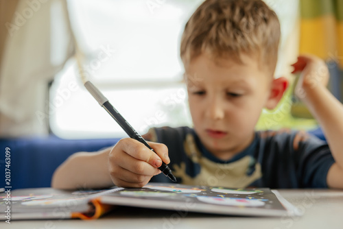 Preschooler doing exercises in a camper van in summer. 