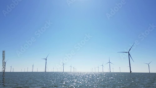 Green energy, wind turbines produce energy in the North Sea, wind farm power plant view from height, alternative energy sources.
