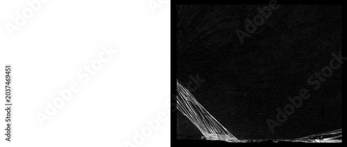 Photos Crumpled plastic wrap texture on black background, transparent cling film overla
