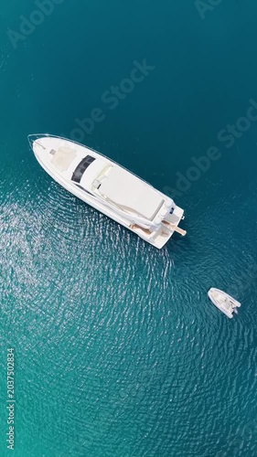 Sailing yacht glides across tranquil blue waters near lush green coastline