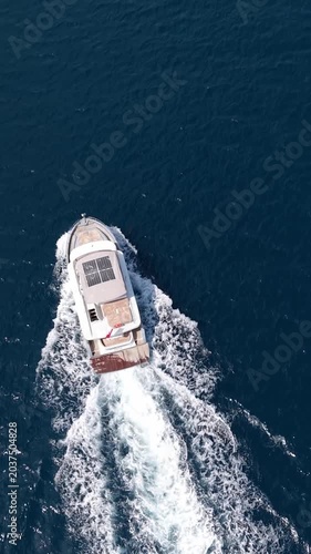 Three yachts sailing together on the deep blue sea, aerial view