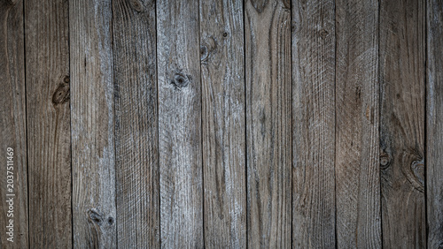 Fotografi Wood planks arranged vertically showing the texture and grain of the wood in a n