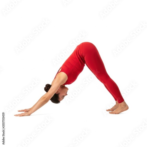 Person practicing downward dog yoga pose with red leggings