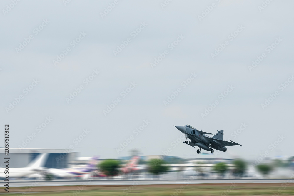 Obraz premium Supersonic fighter jet moving in airport on technology background