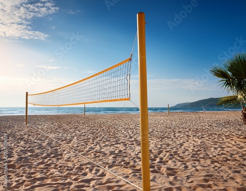 beach volleyball net with sandy court by sea