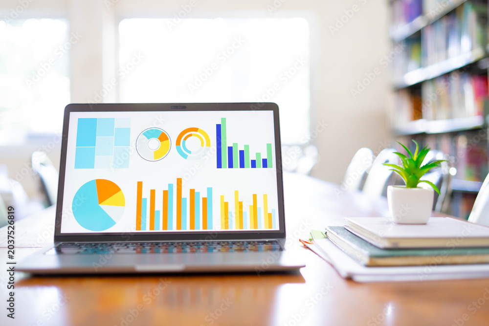 Fototapeta premium Business Analytics Dashboard on Laptop Screen in Library Study Environment