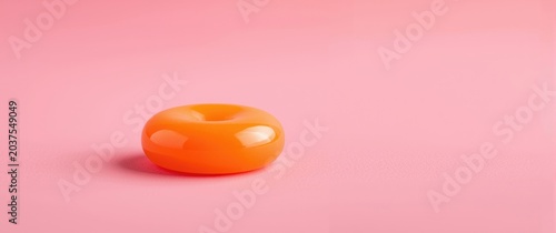 Bright circular candy against a pink backdrop with room for text