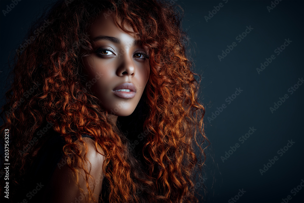 Fototapeta premium Woman Model with Black Skin and Long Red Curly Hair and Grey Eyes, Beauty and Fashion Portrait Concept, Afro-American Female Vogue Aesthetics Studio Closeup