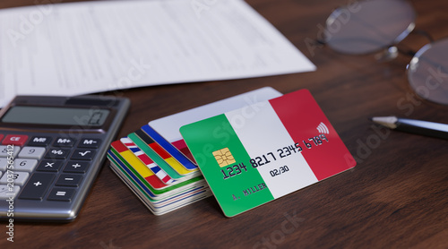 Bank Card Of Italy with pencil, calculator and glasses on desk