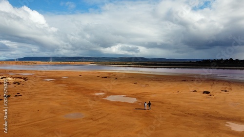 couple walking on red soil landscape
