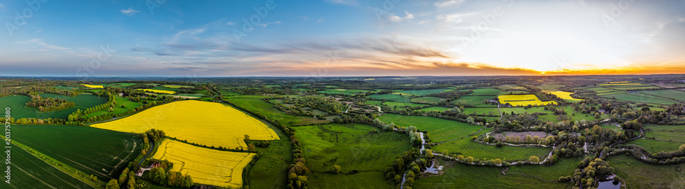 Obraz premium Sunset of Fields and Farms over Horsebridge nad Stockbridge from a drone, Hampshire, England