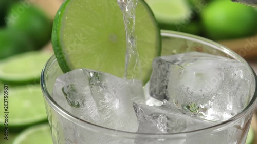 A refreshing glass of water with soda, ice and lime
