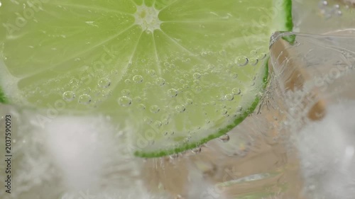 A refreshing glass of water with soda, ice and lime