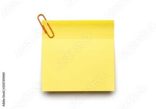 Yellow sticky note with an orange paperclip on top
