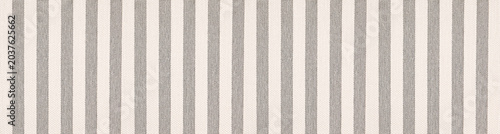 Seamless vertical striped fabric texture featuring alternating beige and grey bands for interior design and upholstery backgrounds.