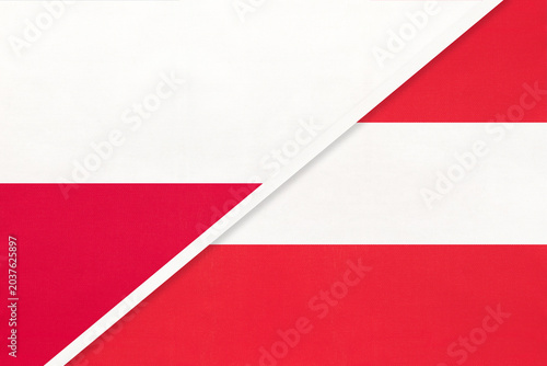 Poland and Austria national flags on fabric background, international partnership and cooperation between two countries