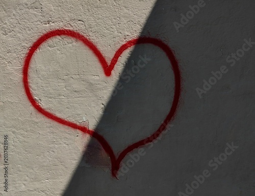 Two Worlds of Love. Light and shadow. Heart shape on the wall.