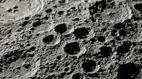 Closeup of the moons surface with craters and rocky terrain