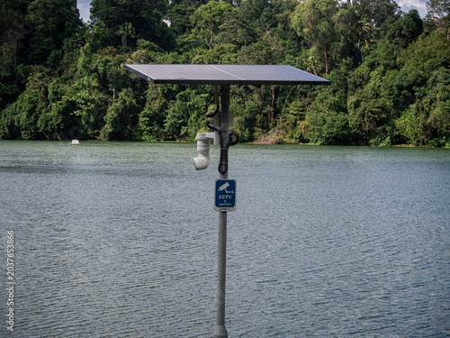 Obraz na plátne Solar powered CCTV camera surveillance overlooking lake and forest
