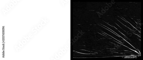 Tableau sur toile Crumpled plastic wrap texture on black background, wrinkled transparent film ove