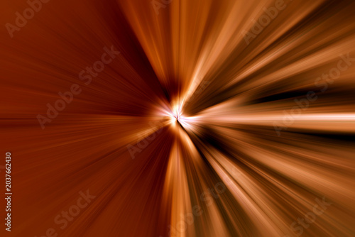 Abstract radial zoom blur with white, orange and brown light streaks on a dark background, radiating from the center and creating a dynamic energetic burst with warm color tones.