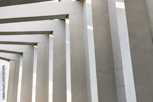 In a masterclass of minimalist geometry, this composition captures a rhythmic dance between light and shadow.A sequence of stark white portals recedes in a diagonal progression,transforming simple str