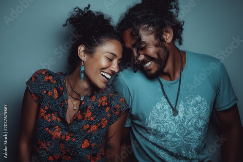 Portrait of a joyful latino couple in their 30s dressed in a casual t-shirt isolated on plain cyclorama studio wall