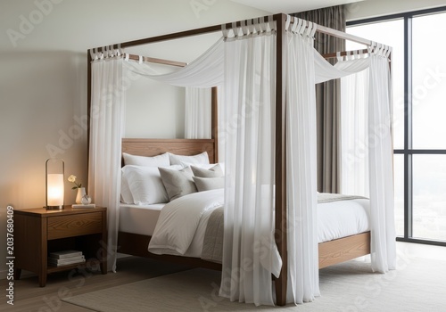 Elegant four-poster bed in a minimalist bedroom setting with sheer curtains