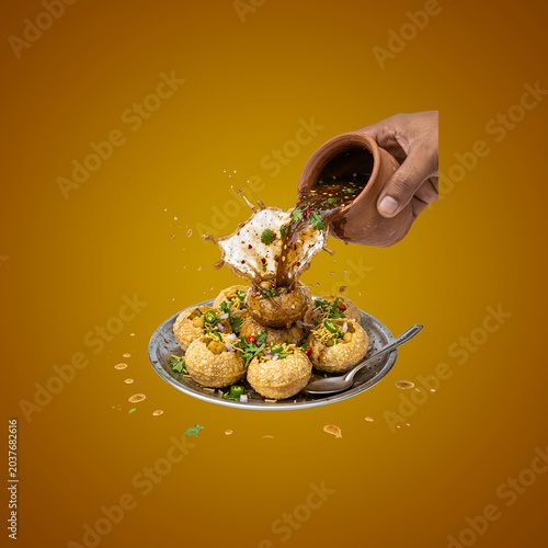 Pouring spices on chaat dish