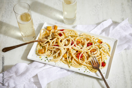Bucatini Basta with Fresh Cherry Tomatoes and Squash and Glasses of Champagne