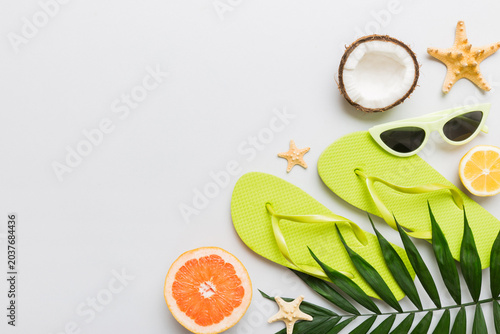 Top view composition of flip flops placed with beach accessories top view on table background. Tropical summer vacation concept Flat lay
