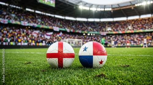 Two soccer balls painted with the national flags of England and Panama side by side on a green stadium grass pitch line, blurred crowded stands background during an international football tournament.