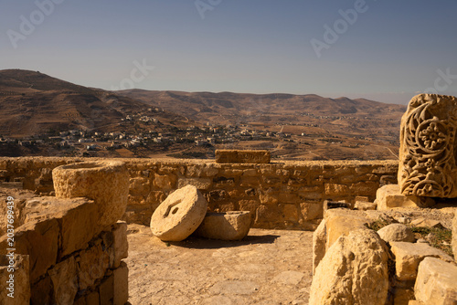 Canvas Print Ancient stone ruins and millstone at Kerak Castle with a scenic view of Al-Karak