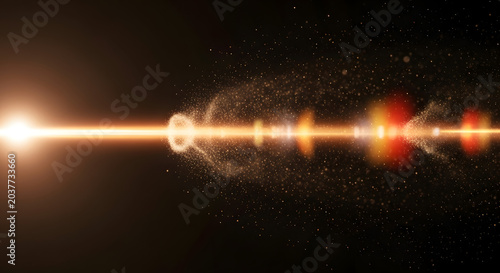 Golden light flare with sparkling dust and lens reflection on a dark background