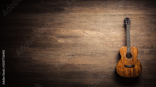 Single acoustic guitar centered on neutral background, warm wood tones with soft shadow, studio top light, minimalist still life