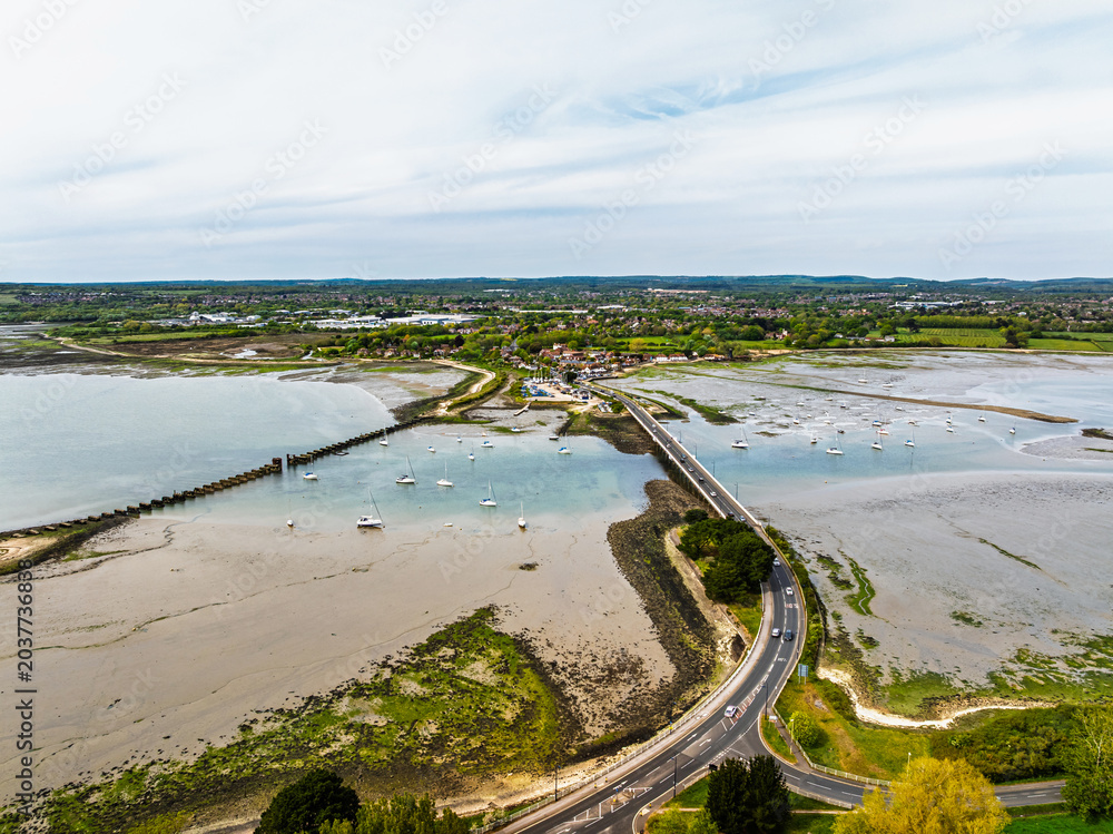 Obraz premium Bridge and Quay to the Hayling Island from a dron at low tide, Havant, Hampshire, England