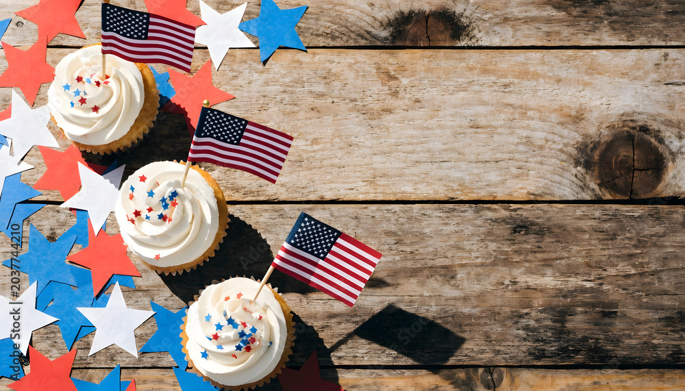 Obraz premium Patriotic cupcakes with american flags and star confetti on a rustic wooden background