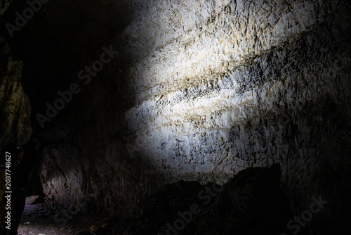 Bild auf Leinwand Illuminated stone wall in a cave in Apuseni Mountains, Romania