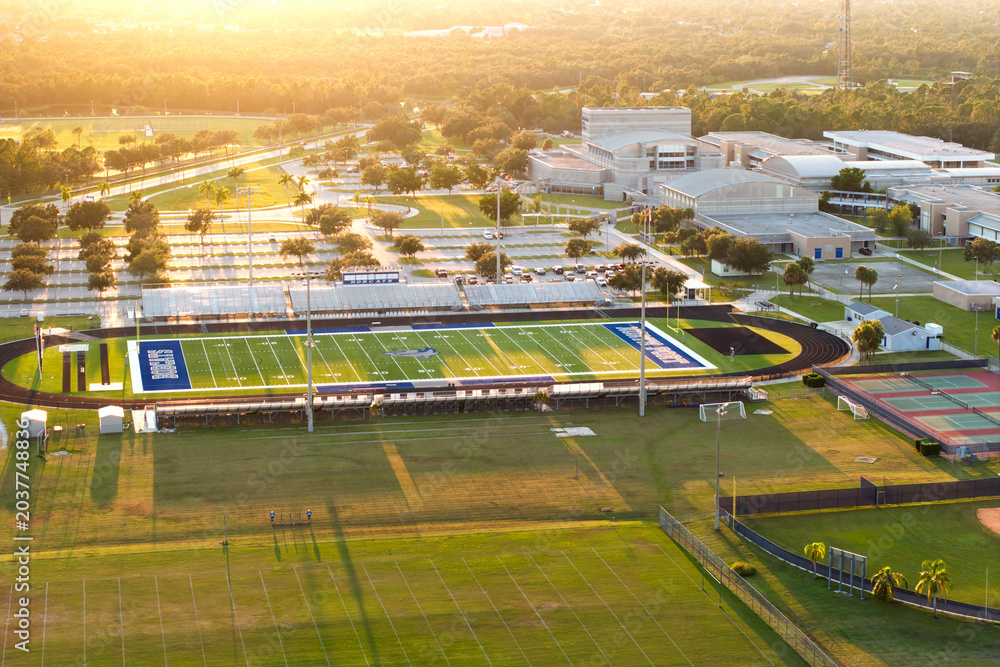 Fototapeta premium Sports facilities at public school in North Port, Florida. American football stadium sport infrastructure. North Port, USA - May 26, 2023.