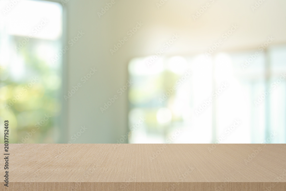 Fototapeta premium abstract blurred garden view form living room window with modern plain wood table counter background for show , promote ,design banner ads on display concept