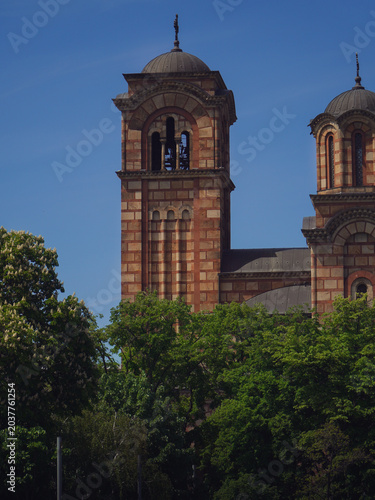 beautiful view of the old green and yellow church tower and the rest of the city