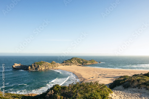 Bild auf Leinwand Wide sandy beach and rocky headland on the South African coast