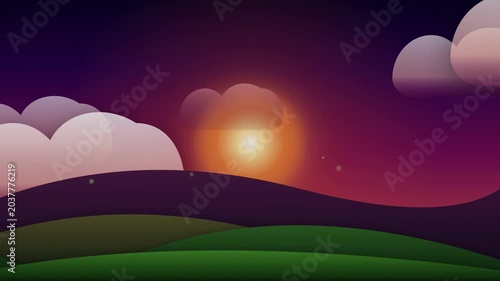 Sunset over hills with clouds in the sky at evening time with green grass
