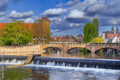 Bild auf Leinwand Close up view of historic Max Bridge with a water weir on Pegnitz river in Nuremberg, Germany