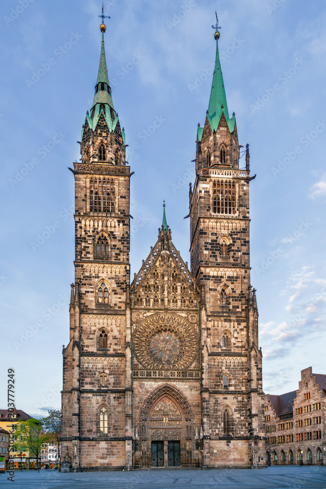 Fototapeta premium Gothic west facade of St. Lorenz Church with twin towers in Nuremberg, Germany. Exterior view, medieval architecture style